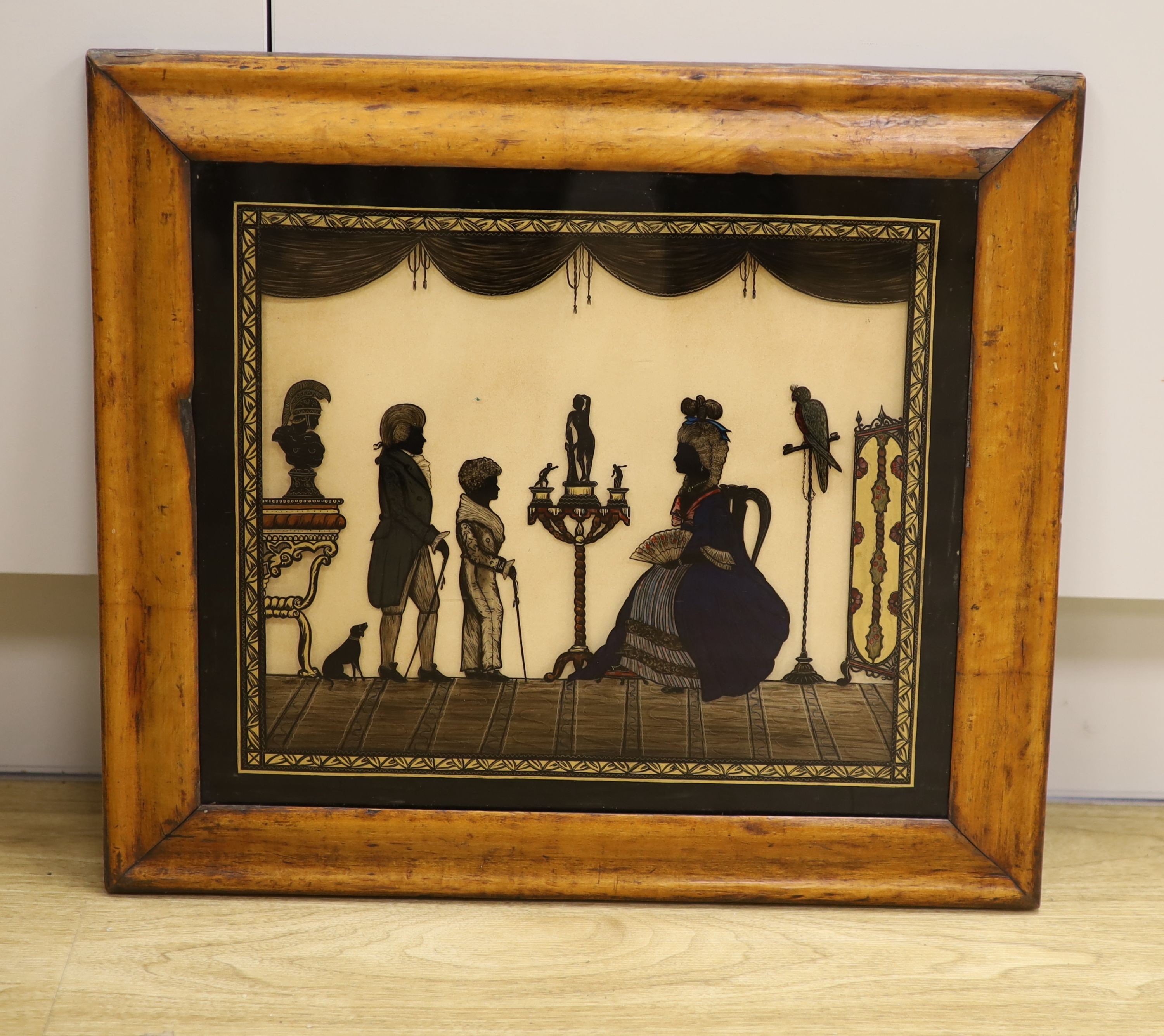 An 18th century style reverse painted glass silhouette, Figures in a drawing room, 31 x 36cm